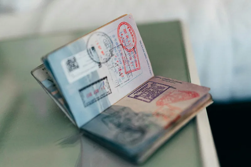 a man holding 2 passport in his hand